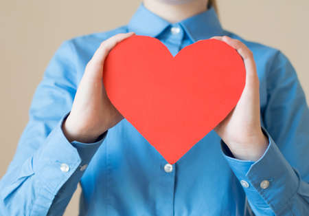 woman holds a heart in his handsの写真素材