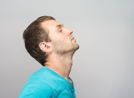 Portrait of Young Caucasian man relaxing with closed eyes