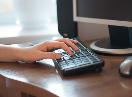 Female office worker typing on the keyboardの写真素材