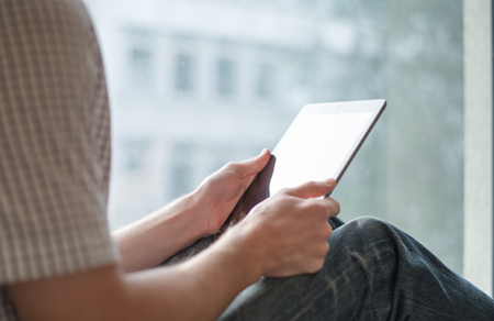 man holding digital tablet, closeup