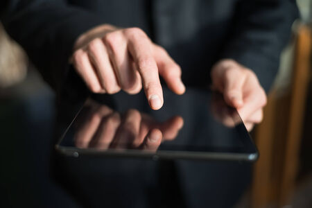 man holding digital tablet, closeupの写真素材