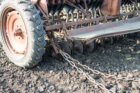 tractor and seeder planting crops on a fieldの写真素材