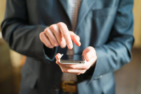 Human hand touches the screen a modern smartphone