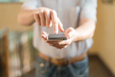 Human hand touches the screen a modern smartphoneの写真素材
