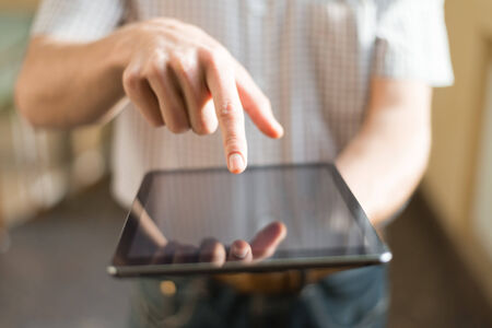 Man hand touching screen on modern digital tablet pcの写真素材