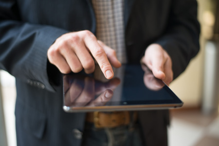 Man hand touching screen on modern digital tablet pc