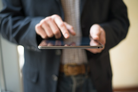 Man hand touching screen on modern digital tablet pc