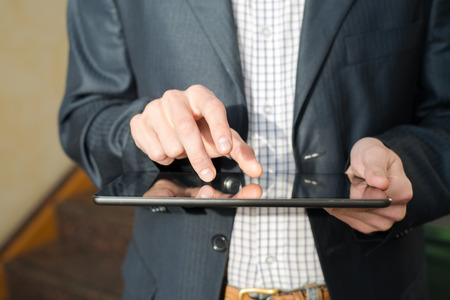 Man hand touching screen on modern digital tablet pc