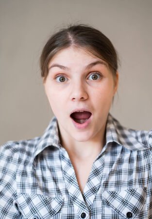 Close-up of a young woman looking surprisedの写真素材