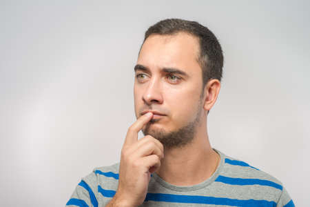 Portrait of the young  thinking man looks upの写真素材