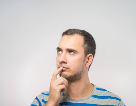 Portrait of the young  thinking man looks upの写真素材