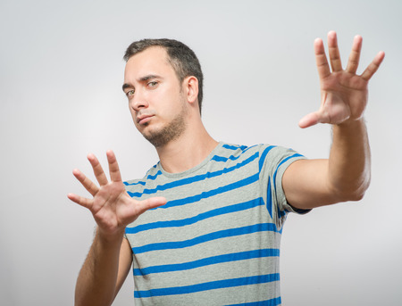 frightened man defends himself with his handsの写真素材