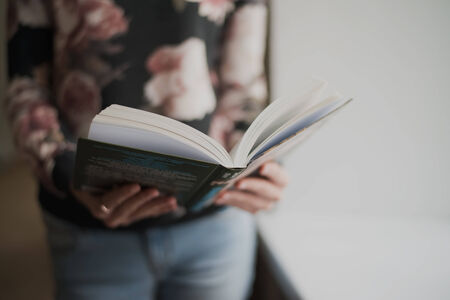overhead view of hands holding a blank bookの写真素材