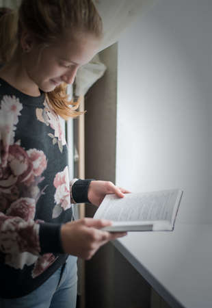 young beautiful girl reading a bookの写真素材