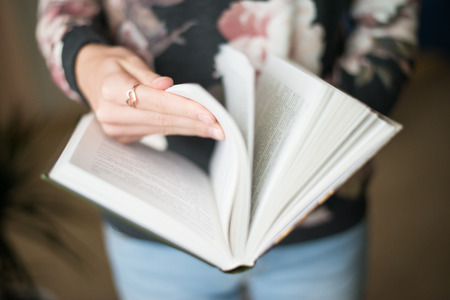 overhead view of hands holding a blank bookの写真素材