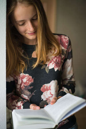 young beautiful girl reading a bookの写真素材