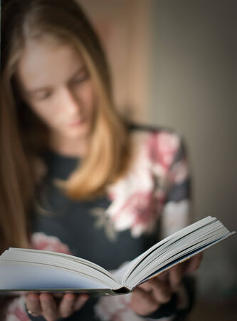young beautiful girl reading a bookの写真素材