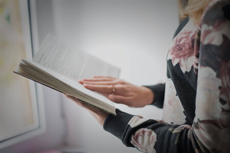 overhead view of hands holding a blank bookの写真素材