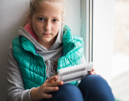 pretty young girl uses the phoneの写真素材