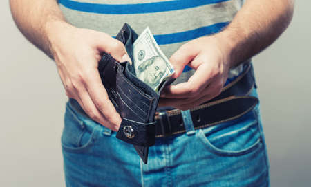 Man gets $ 100 from her purseの写真素材