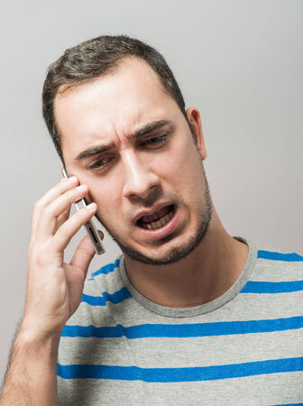 casual young man talking on the phoneの写真素材