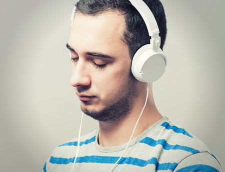 Handsome young man putting on headphonesの写真素材