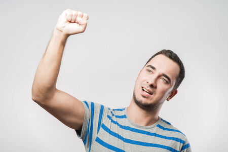 Handsome young man showing his bicepsの写真素材