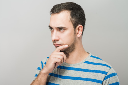 Depressed young man  holding head in handsの写真素材