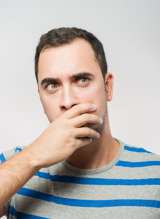 Depressed young man  holding head in handsの写真素材