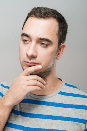 Depressed young man  holding head in handsの写真素材