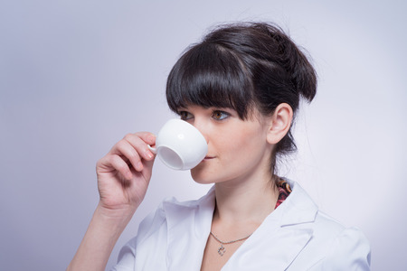 Beautiful Girl Drinking Tea or Coffee.の写真素材