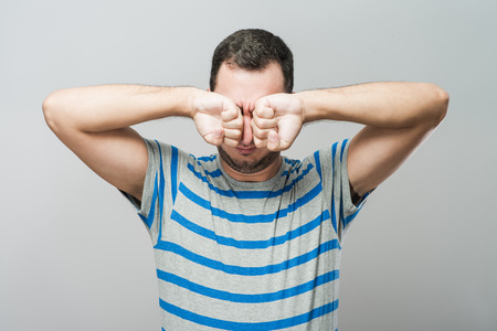 Man covering his hearsの写真素材