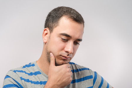 Depressed young man  holding head in handsの写真素材
