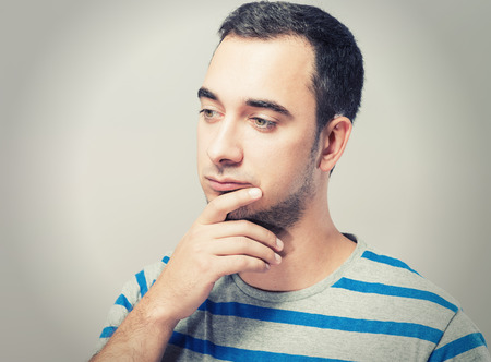 Depressed young man  holding head in handsの写真素材