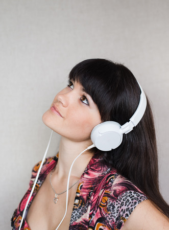 Young motion woman with headphones listening musicの写真素材