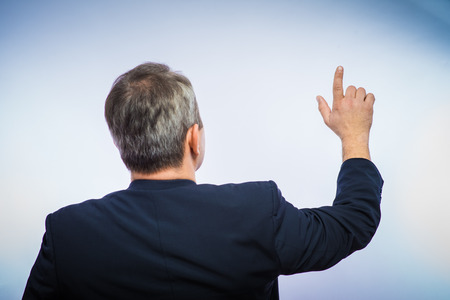 businessman in formal wear pushing forefinger screenの写真素材