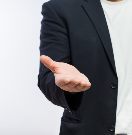 Businessman offering for handshake over white background. Copy space.の写真素材