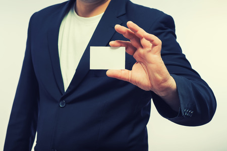 Businessman showing the big blank card in handの写真素材