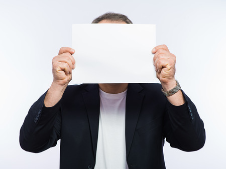 Businessman showing the big blank card in handの写真素材