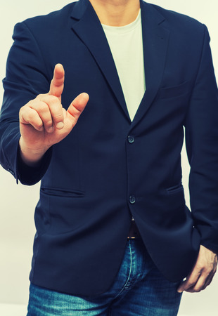 businessman in formal wear pushing forefinger screenの写真素材