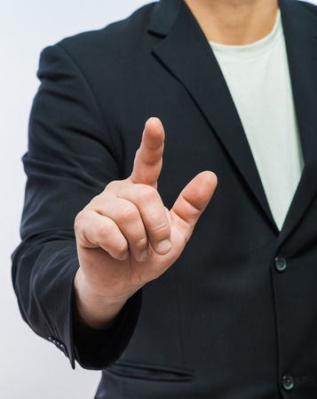 businessman in formal wear pushing forefinger screenの写真素材