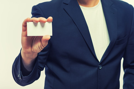 Businessman showing the big blank card in handの写真素材