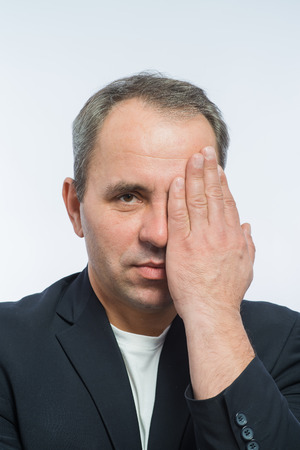 Businessman covering his face with both handsの写真素材
