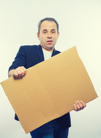 Businessman showing the big blank card in handの写真素材