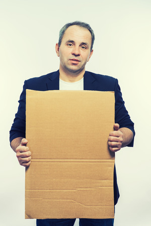 Businessman showing the big blank card in handの写真素材