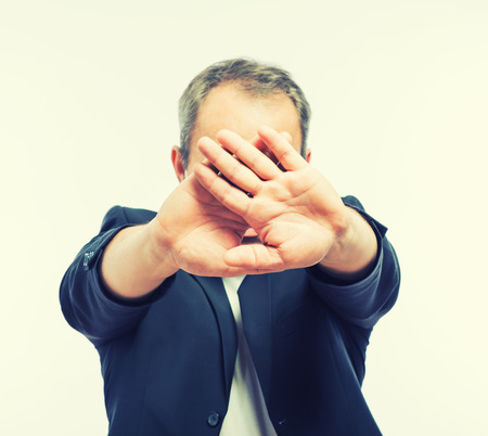 Businessman covering his face with both handsの写真素材