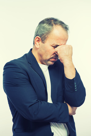 Businessman covering his face with both handsの写真素材