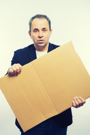 Businessman showing the big blank card in handの写真素材