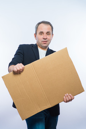 Businessman showing the big blank card in handの写真素材