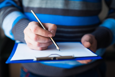 businessman holding a clipboard and write on itの写真素材